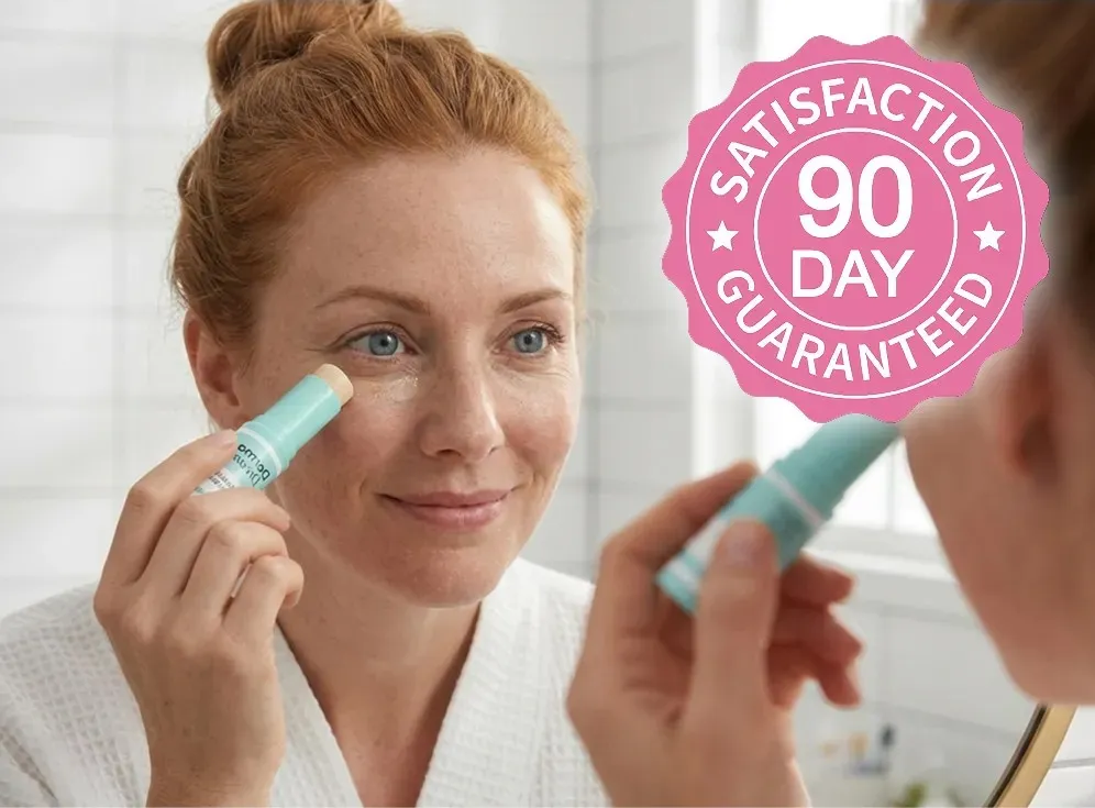 Woman applying a calcium balm stick in front of a mirror